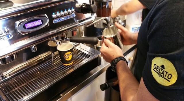 Milk being steamed at a café espresso machine
