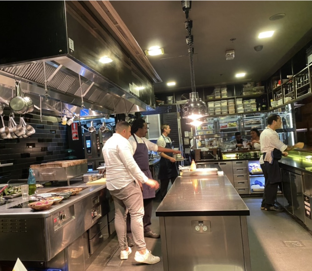 Paul in a busy commercial kitchen with chefs