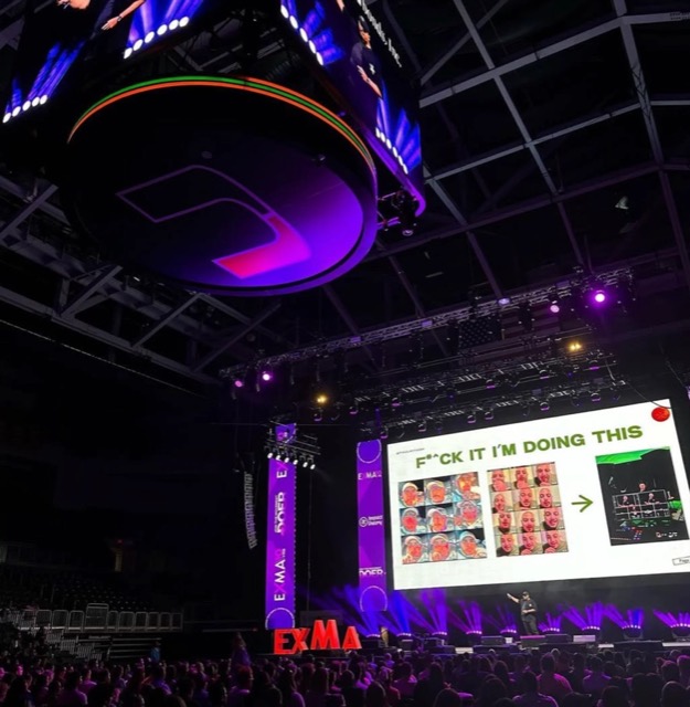 Paul on stage at ExMA in front of a packed arena