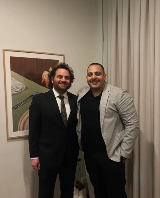 Paul with an operator at an evening event